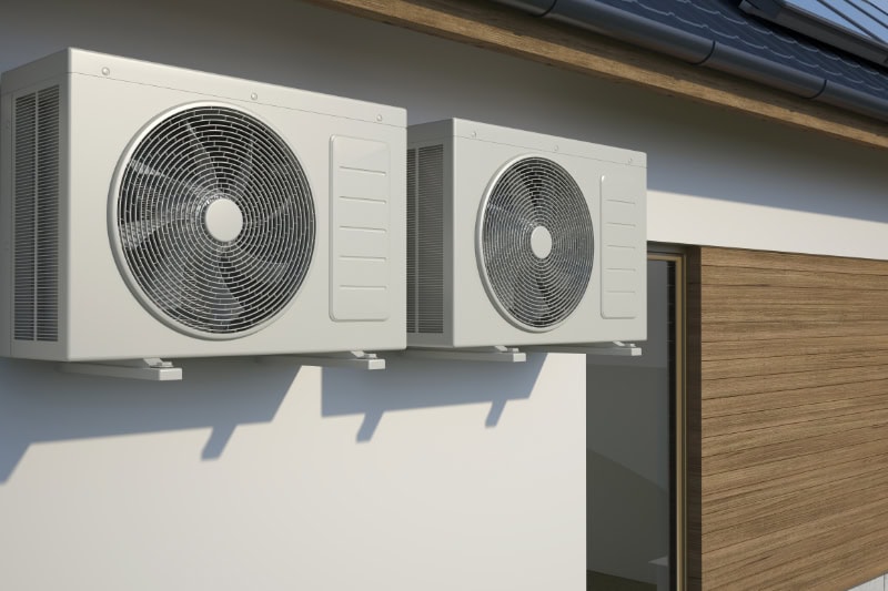 two outdoor ac units outside of a home.