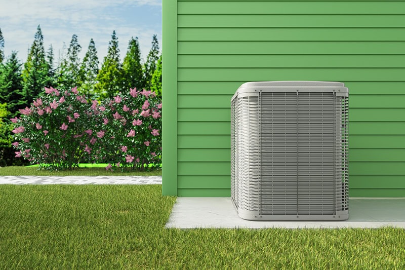 HVAC condenser unit installed on a concrete pad.