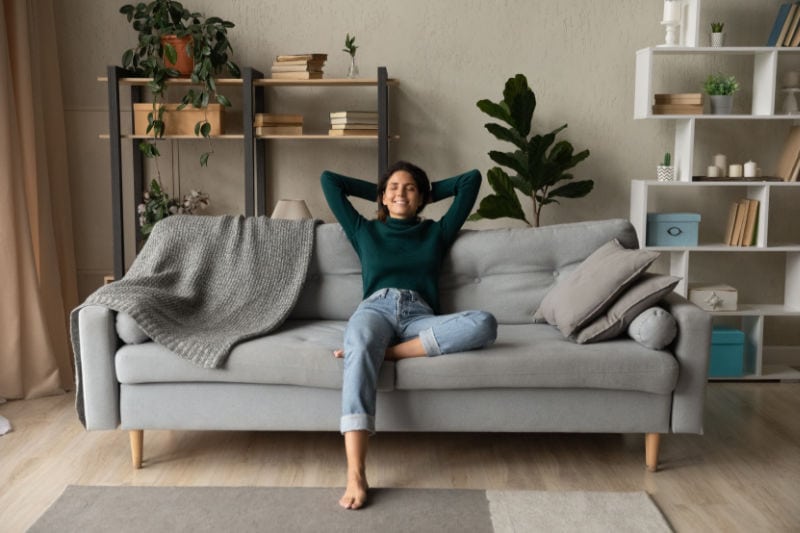 A lady sitting on a couch.