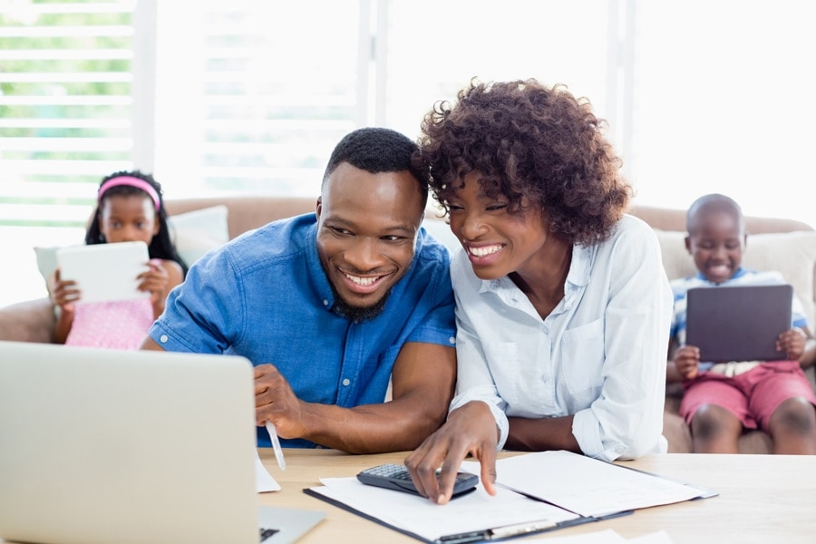 Happy couple looking at their laptop.